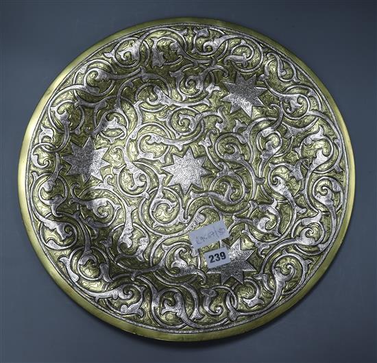 An Islamic white metal and brass charger diameter 45cm